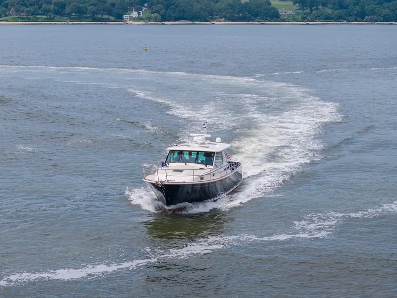 Slide: The Image of 2024 Sabre 43 Salon Express cruising on open water. - 24