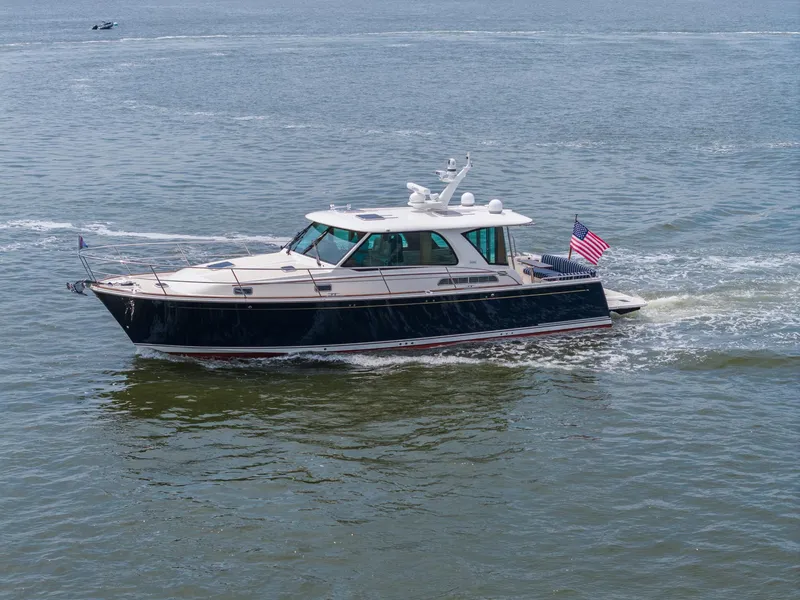 Slide: The Image of 2024 Sabre 43 Salon Express yacht cruising on open water with American flag. - 26