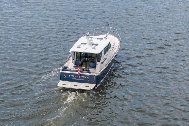 Slide: The Image of 2024 Sabre 43 Salon Express yacht cruising on open water. - 3