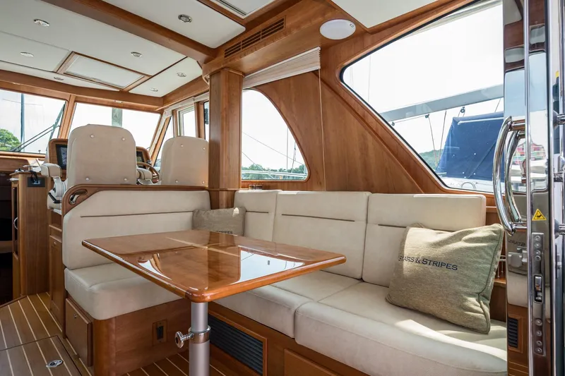 Slide: The Image of 2024 Sabre 43 Salon Express interior with elegant seating and wooden accents. - 33