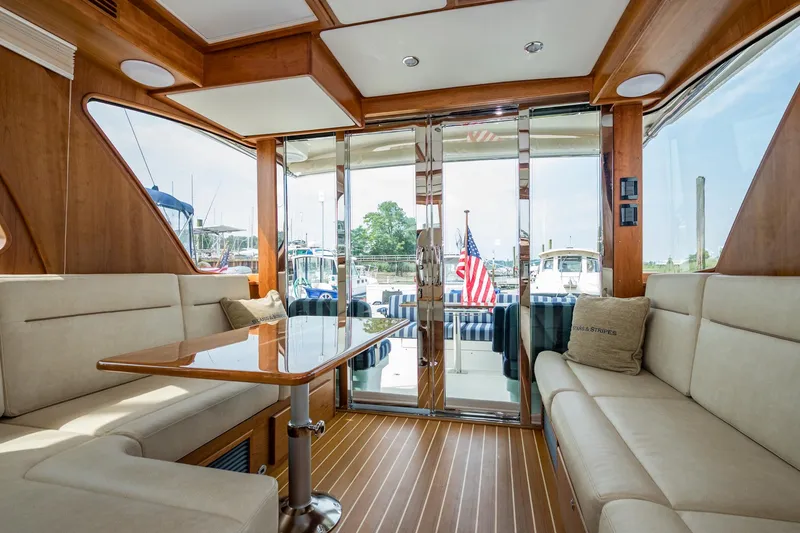 Slide: The Image of 2024 Sabre 43 Salon Express interior with elegant seating and wooden finishes. - 36