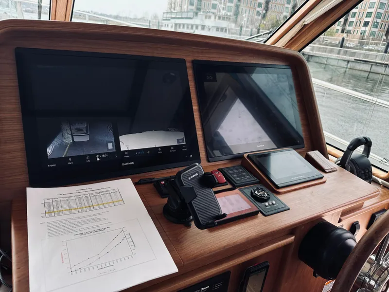 Slide: The Image of 2024 Sabre 43 Salon Express helm with navigation screens and control panel. - 37