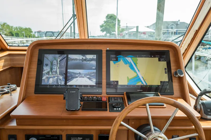 Slide: The Image of 2024 Sabre 43 Salon Express helm with dual navigation screens and wooden steering wheel. - 38