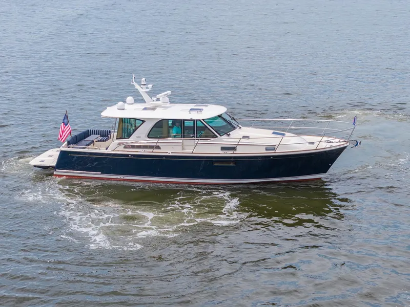 Slide: The Image of 2024 Sabre 43 Salon Express yacht cruising on open water. - 4