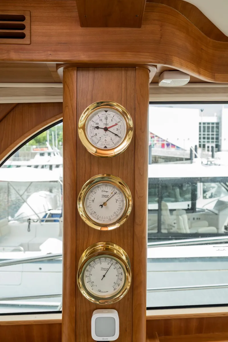 Slide: The Image of 2024 Sabre 43 Salon Express interior with brass gauges and wooden paneling. - 40