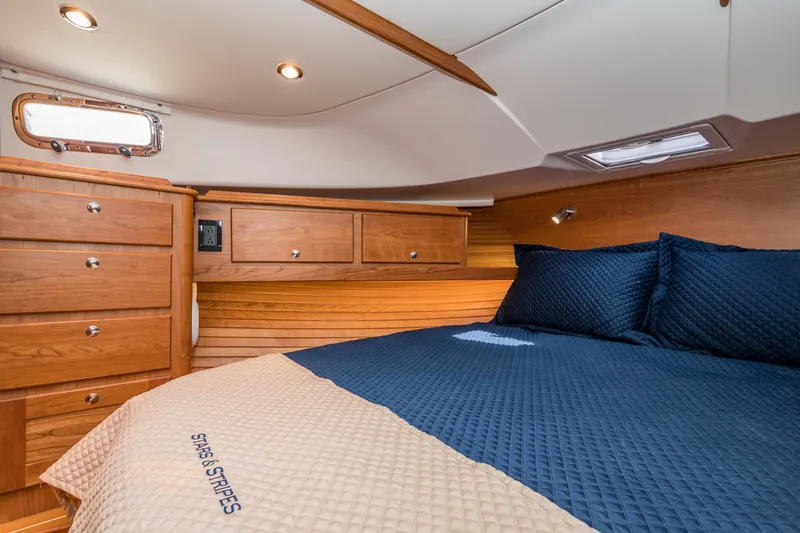 Slide: The Image of Luxurious cabin interior of 2024 Sabre 43 Salon Express yacht with wood finish and cozy bedding. - 45