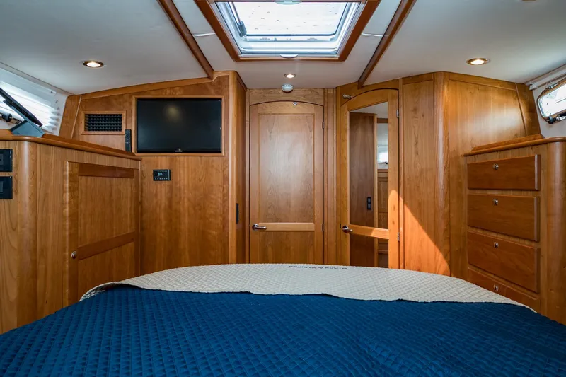 Slide: The Image of 2024 Sabre 43 Salon Express cabin with wood interior, skylight, and TV. - 47