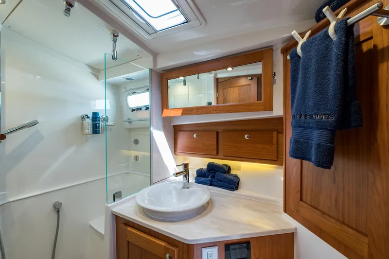 Slide: The Image of Luxurious bathroom in 2024 Sabre 43 Salon Express yacht with modern fixtures and wooden cabinetry. - 49