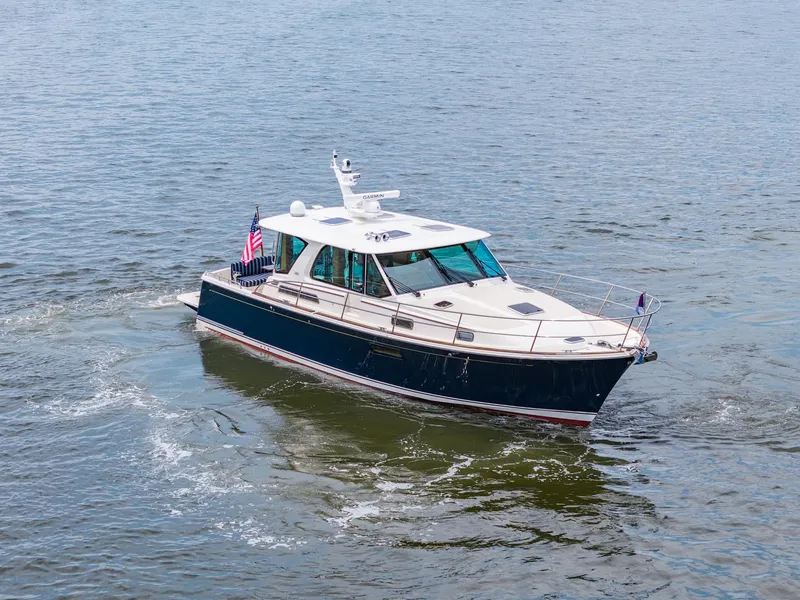 Slide: The Image of 2024 Sabre 43 Salon Express yacht cruising on open water. - 5