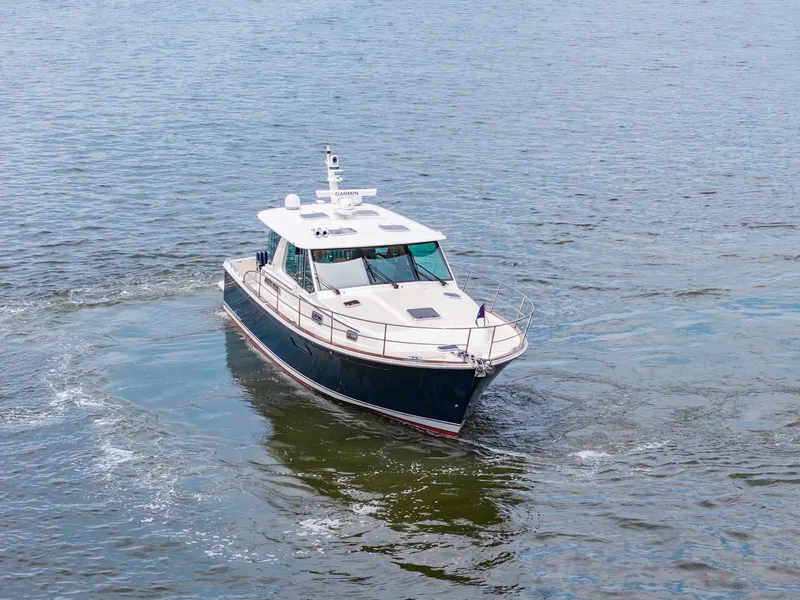 Slide: The Image of 2024 Sabre 43 Salon Express yacht cruising on open water. - 6