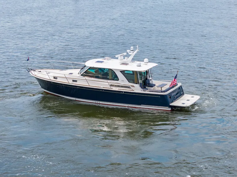 Slide: The Image of 2024 Sabre 43 Salon Express yacht cruising on open water. - 9