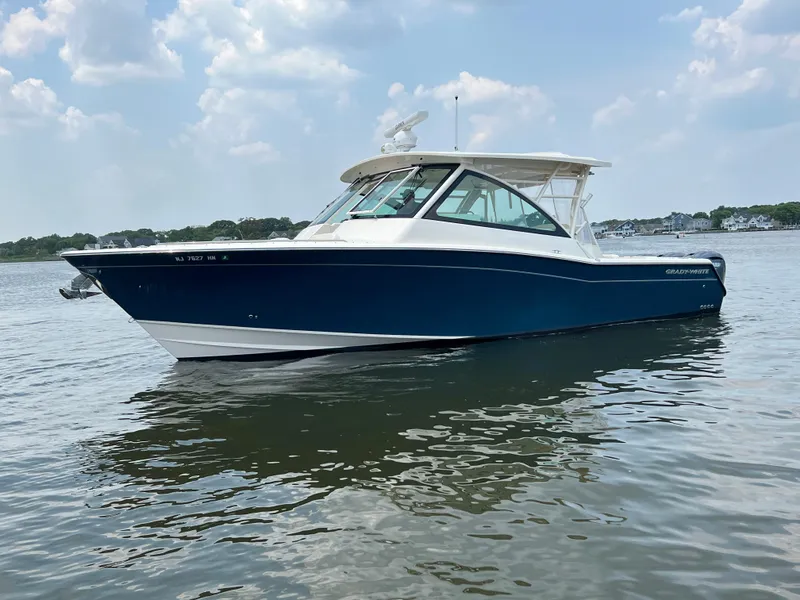 Slide: The Image of 2020 Grady-White Freedom 375 boat on calm water under a partly cloudy sky. - 11