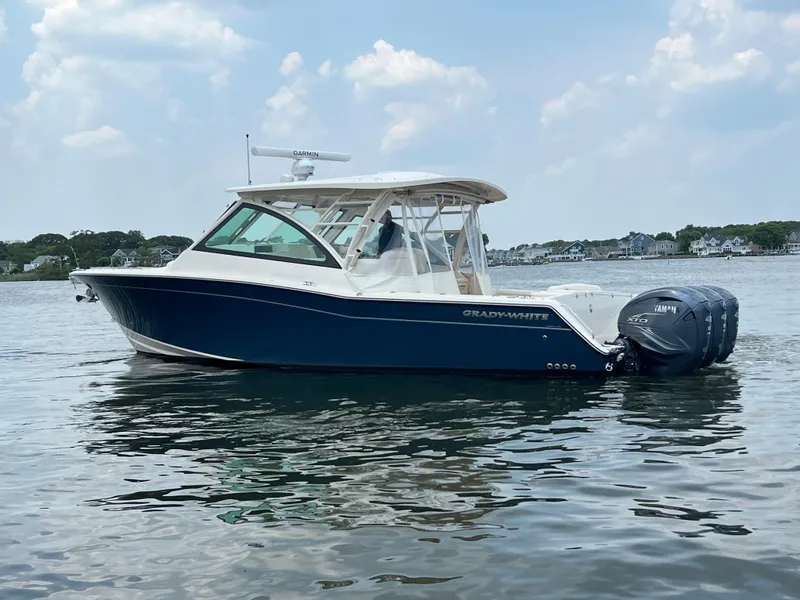 Slide: The Image of 2020 Grady-White Freedom 375 boat on calm water under a cloudy sky. - 13