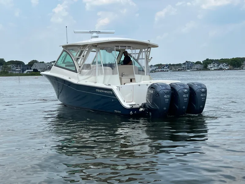 Slide: The Image of 2020 Grady-White Freedom 375 boat with triple outboard engines on calm water. - 15