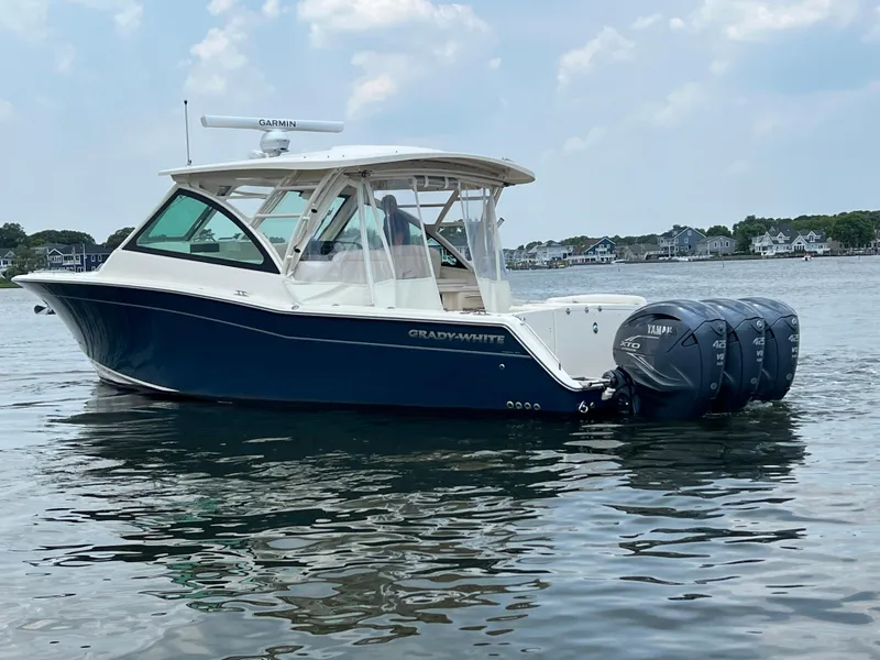 Slide: The Image of 2020 Grady-White Freedom 375 boat on water with triple outboard engines. - 2