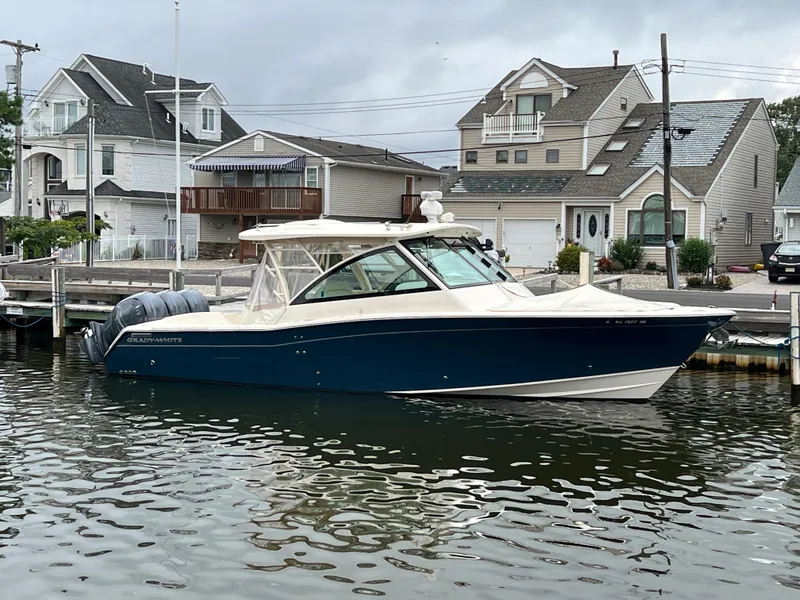 Slide: The Image of 2020 Grady-White Freedom 375 boat docked near waterfront homes. - 20