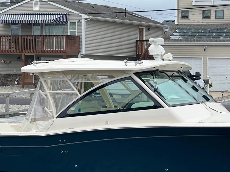 Slide: The Image of 2020 Grady-White Freedom 375 boat docked near residential homes. - 21