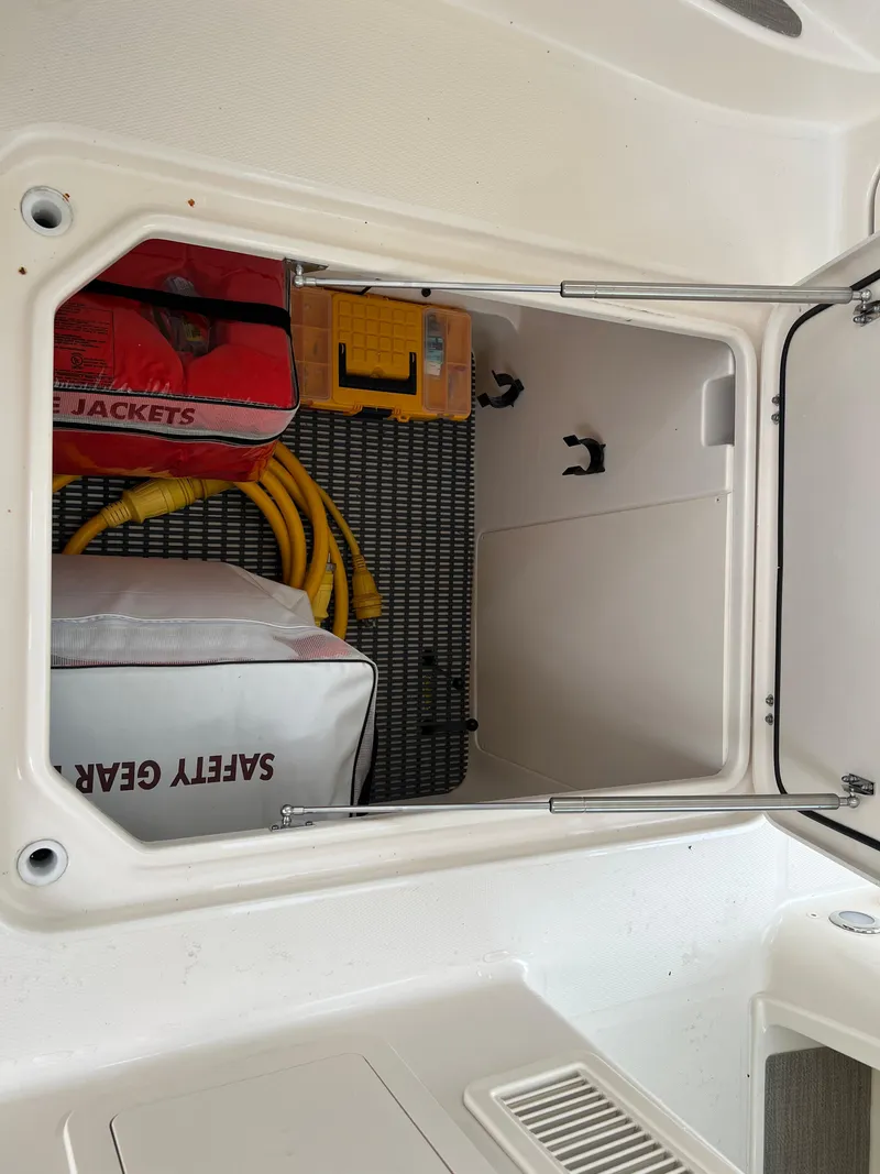 Slide: The Image of Storage compartment in 2020 Grady-White Freedom 375 boat with safety gear and life jackets. - 25