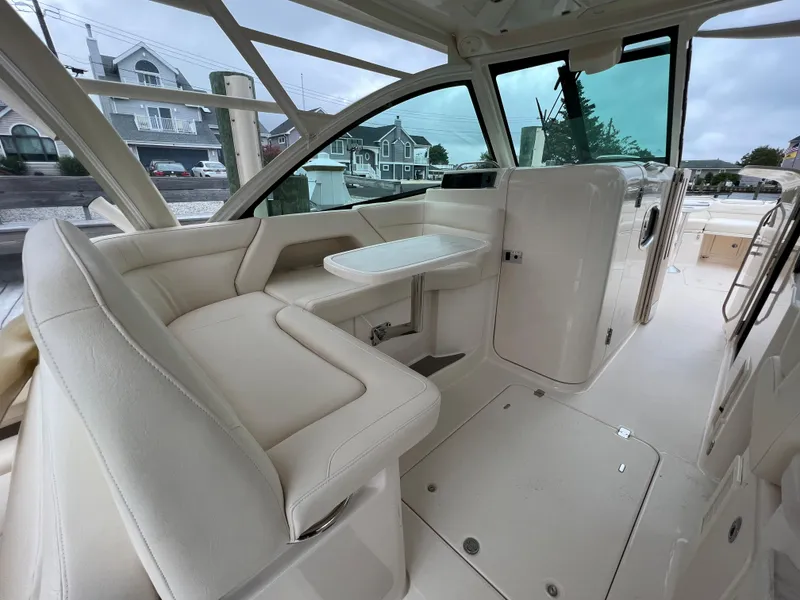 Slide: The Image of 2020 Grady-White Freedom 375 boat interior with beige seating and table. - 27