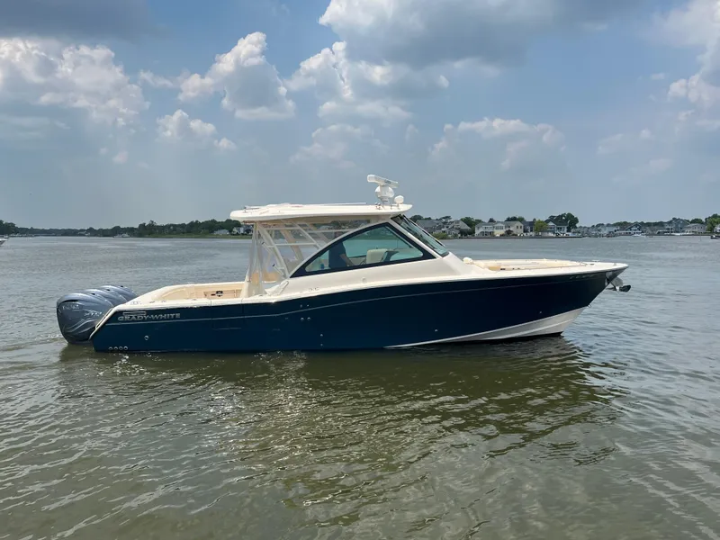 Slide: The Image of 2020 Grady-White Freedom 375 boat on calm water under a partly cloudy sky. - 3