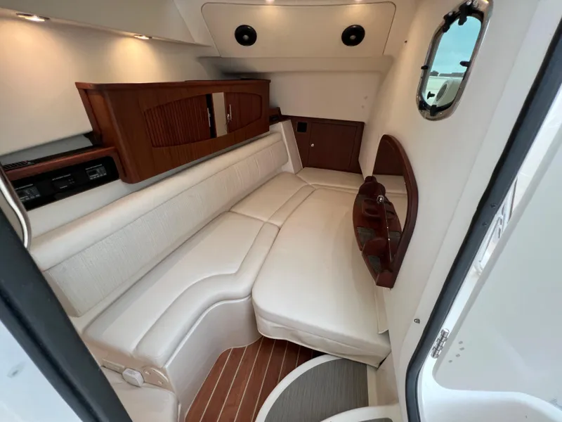 Slide: The Image of 2020 Grady-White Freedom 375 cabin interior with white seating and wood accents. - 31
