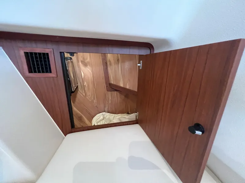 Slide: The Image of 2020 Grady-White Freedom 375 interior cabin with wooden door and vent. - 34
