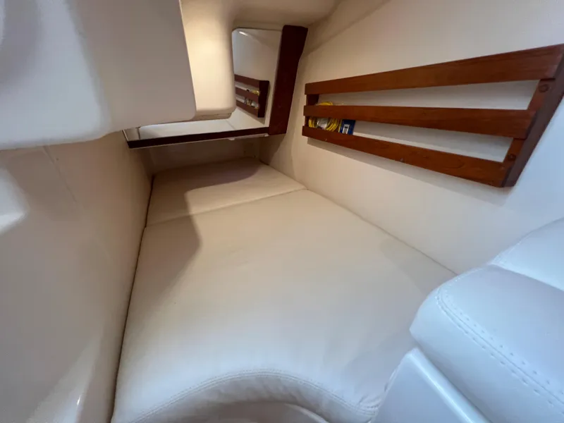 Slide: The Image of 2020 Grady-White Freedom 375 cabin interior with cushioned seating and wooden accents. - 35