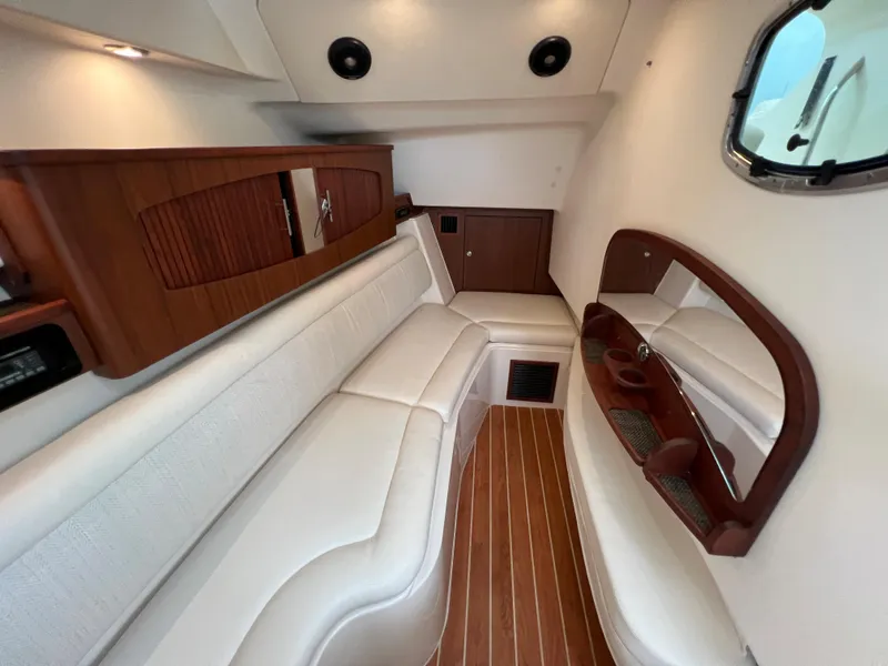 Slide: The Image of 2020 Grady-White Freedom 375 cabin interior with white seating and wood accents. - 37