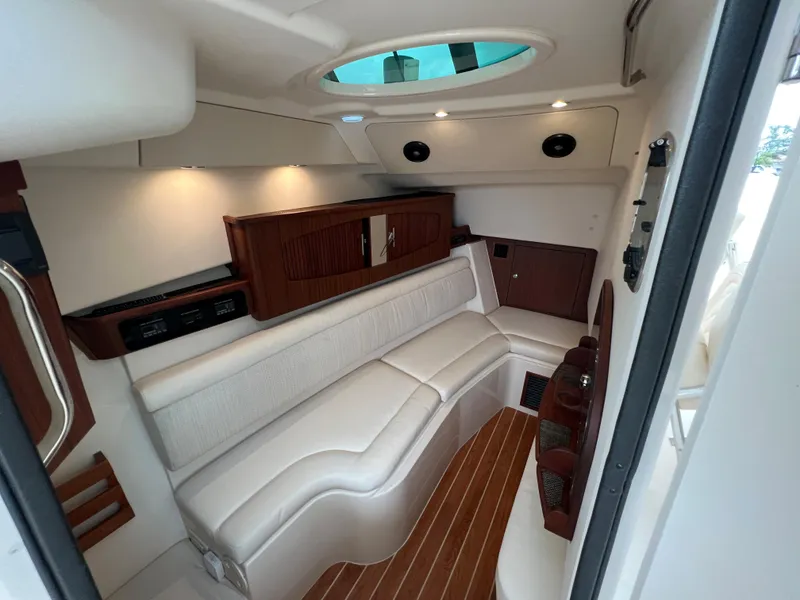 Slide: The Image of 2020 Grady-White Freedom 375 cabin interior with plush seating and wood accents. - 38
