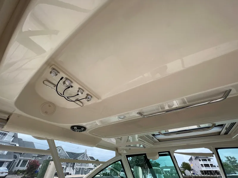 Slide: The Image of 2020 Grady-White Freedom 375 boat interior ceiling with controls and skylight. - 40