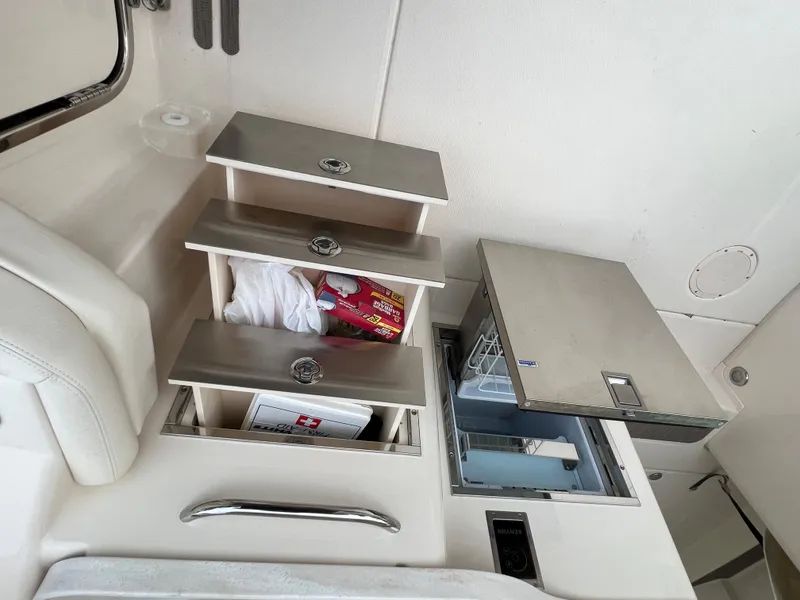 Slide: The Image of 2020 Grady-White Freedom 375 boat interior with storage drawers and cooler. - 44