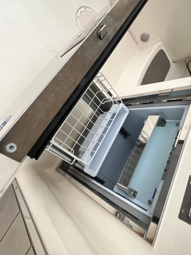 Slide: The Image of 2020 Grady-White Freedom 375 boat interior with open storage compartment. - 45