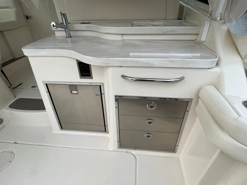 Slide: The Image of 2020 Grady-White Freedom 375 boat interior with sleek kitchenette and stainless steel storage. - 46