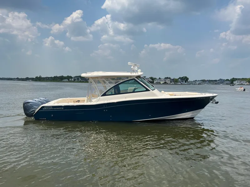 Slide: The Image of 2020 Grady-White Freedom 375 boat on calm water under a partly cloudy sky. - 5