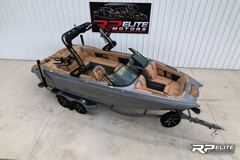 Slide: The Image of 2025 MasterCraft X22 boat with tan interior on a trailer at RP Elite Motors. - 1