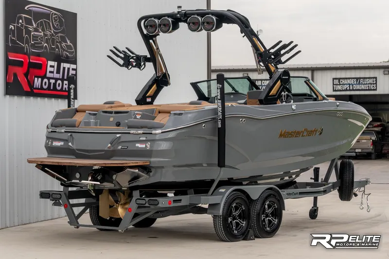 Slide: The Image of 2025 MasterCraft X22 boat on trailer at RP Elite Motors showroom. - 14