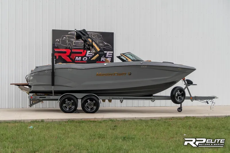 Slide: The Image of 2025 MasterCraft X22 boat on trailer, displayed at RP Elite Motors. - 15