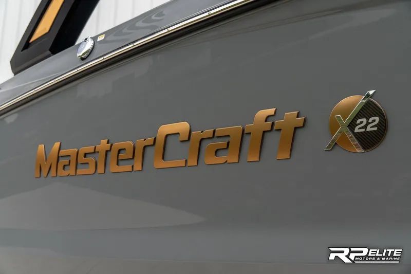 Slide: The Image of 2025 MasterCraft X22 boat logo on sleek gray surface. - 18