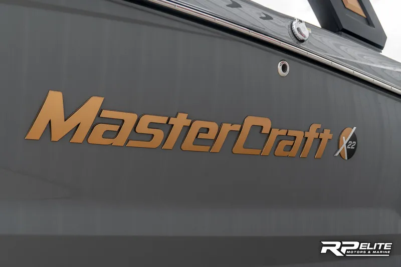 Slide: The Image of 2025 MasterCraft X22 boat logo on a sleek, dark hull. - 25