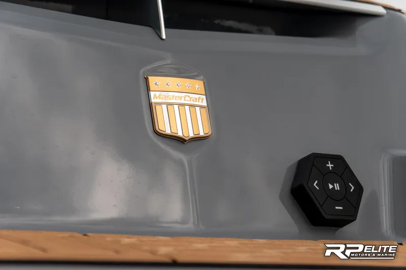 Slide: The Image of 2025 MasterCraft X22 boat emblem and control panel on gray surface. - 35