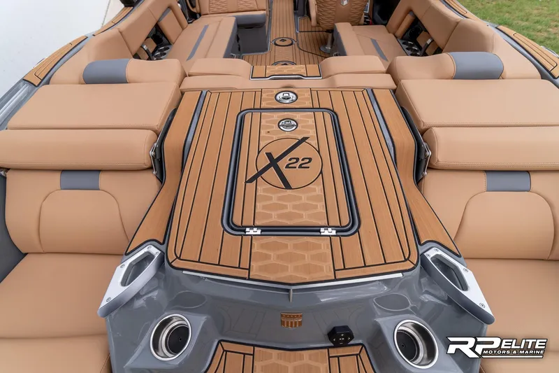 Slide: The Image of 2025 MasterCraft X22 boat interior with tan seating and sleek design. - 48