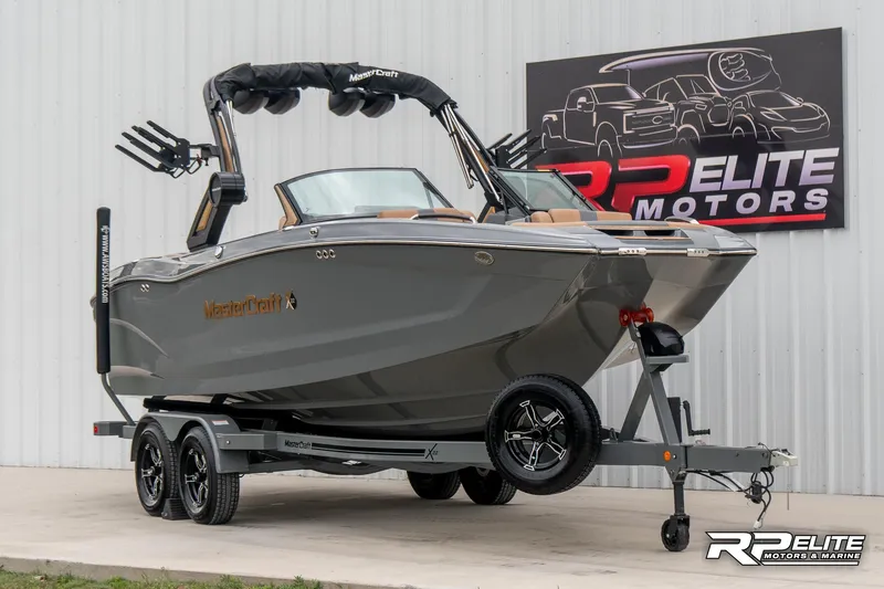 Slide: The Image of 2025 MasterCraft X22 boat on trailer at RP Elite Motors showroom. - 7