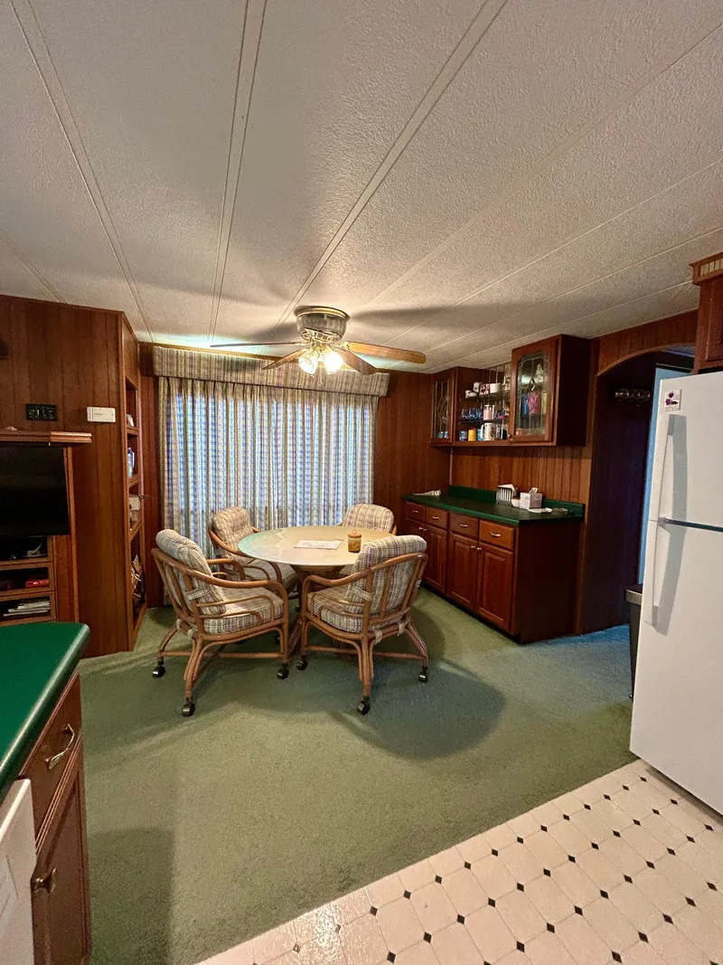 Slide: The Image of Interior of a 2001 Jamestowner houseboat with dining area and kitchen. - 12