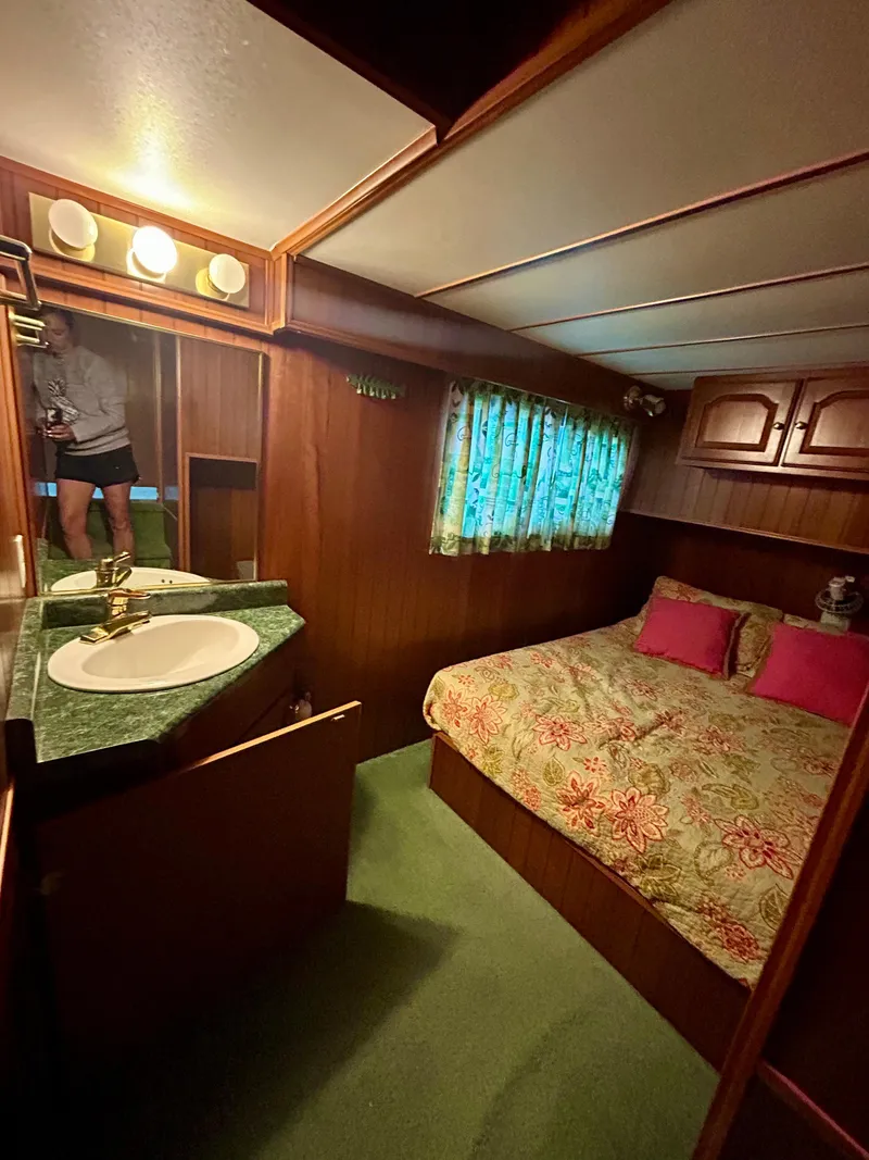 Slide: The Image of Cozy bedroom in 2001 Jamestowner houseboat with floral bedding and wooden interior. - 18