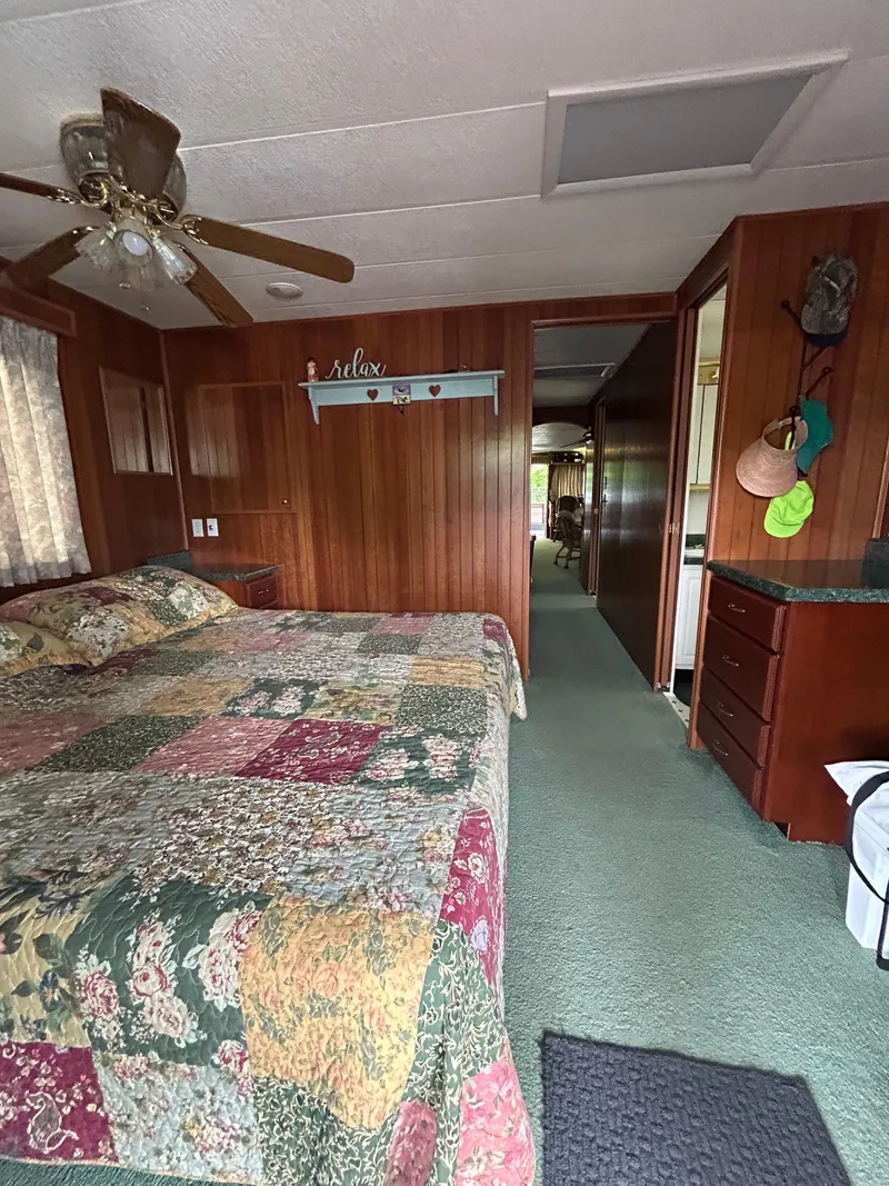 Slide: The Image of Interior of 2001 Jamestowner houseboat with cozy bedroom and colorful quilt. - 19