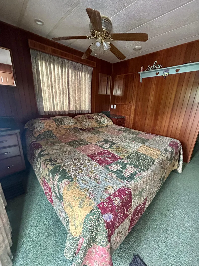 Slide: The Image of Cozy bedroom in 2001 Jamestowner houseboat with patchwork quilt and ceiling fan. - 20
