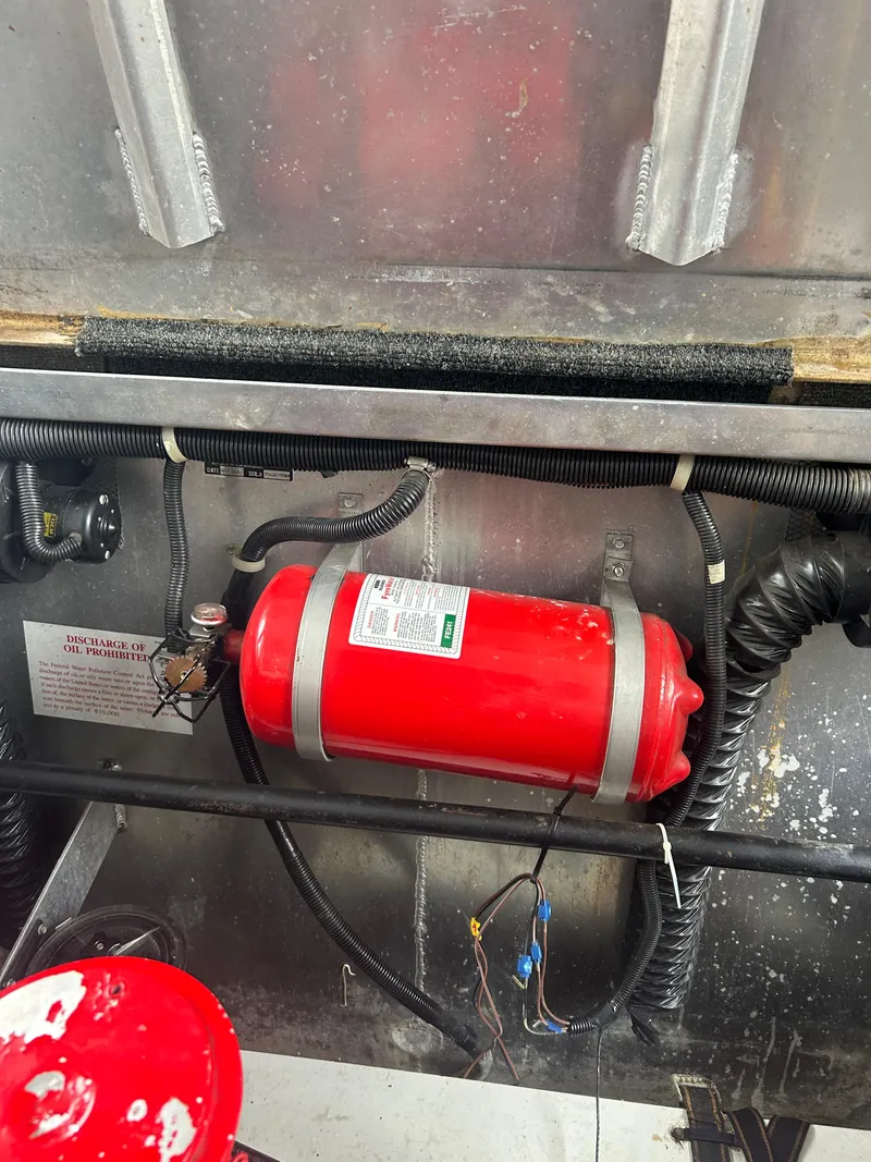 Slide: The Image of Red fire extinguisher in a 2001 Jamestowner houseboat engine compartment. - 28