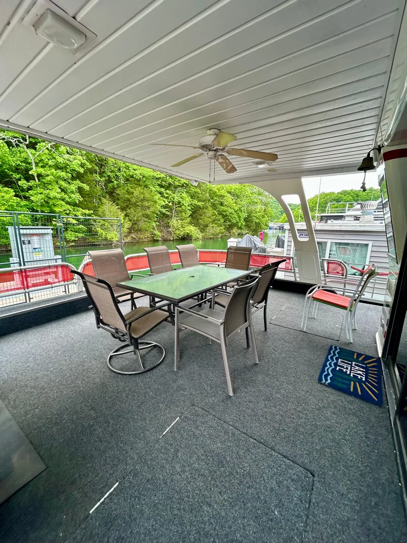 Slide: The Image of Spacious 2001 Jamestowner houseboat deck with outdoor seating and ceiling fan. - 4
