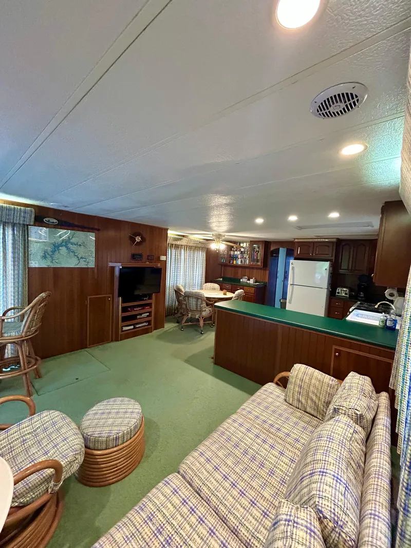 Slide: The Image of Interior of a 2001 Jamestowner houseboat with cozy seating and kitchen area. - 8