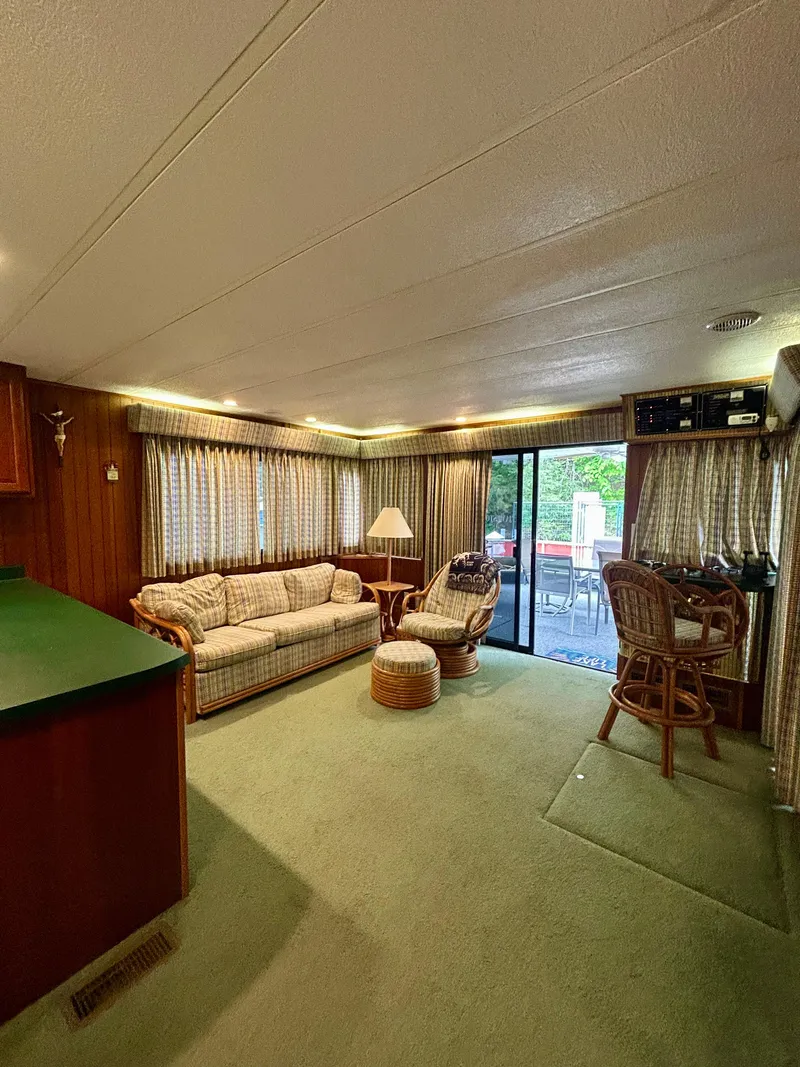 Slide: The Image of Interior of a 2001 Jamestowner houseboat with cozy seating and natural light. - 9